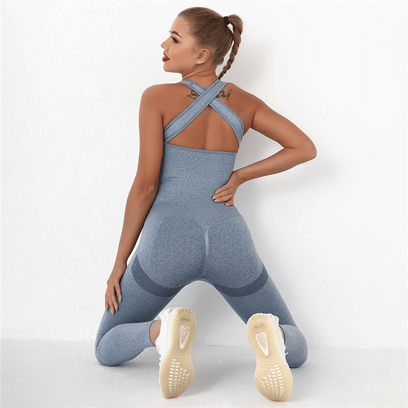 Model wearing seamless high waist bodysuit with hip push-up in blue, showcasing women's gym clothing made of nylon and spandex.