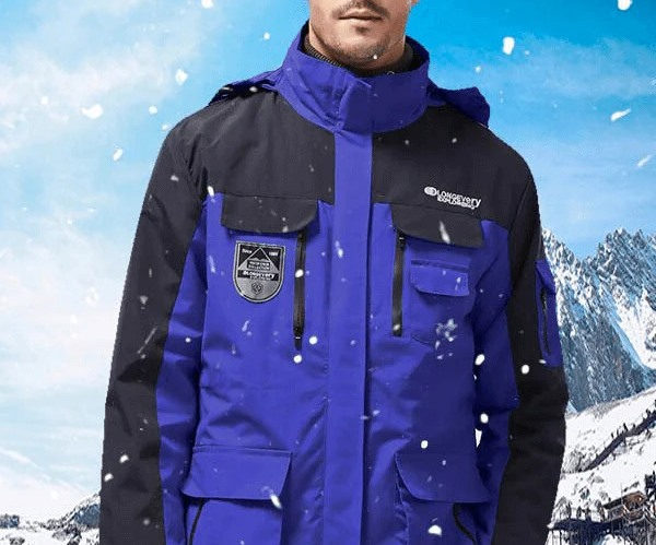 Blue and black men’s insulated ski jacket with high collar in snowy mountain scene