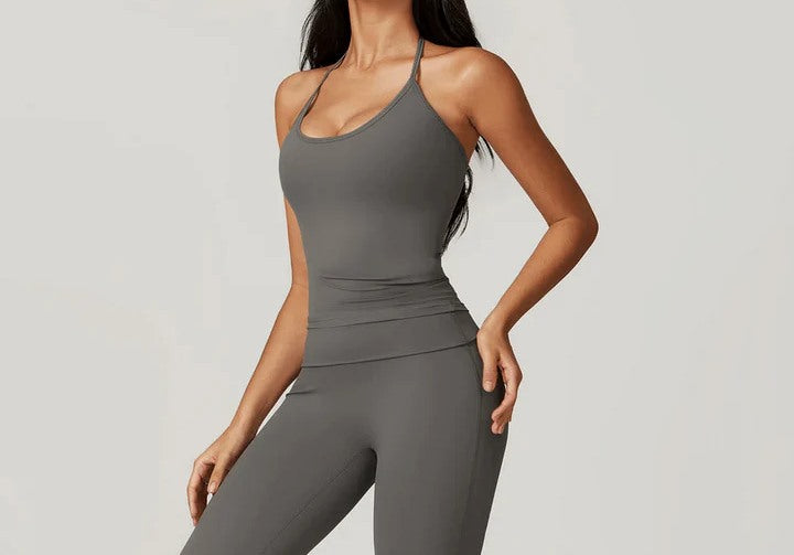 Women’s grey fitted yoga tank top with spaghetti straps, paired with matching high-waist leggings.
