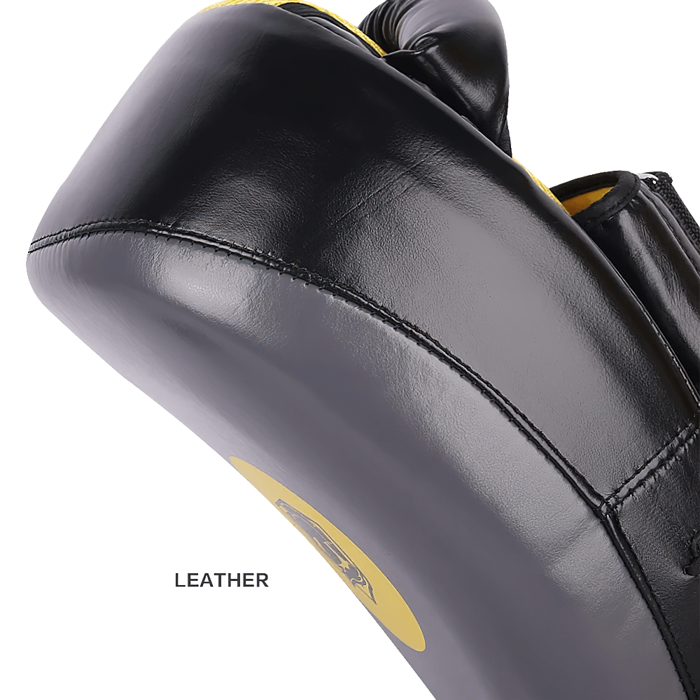 Durable leather Muay Thai kick pad with dual arm straps and reinforced stitching for effective martial arts training.