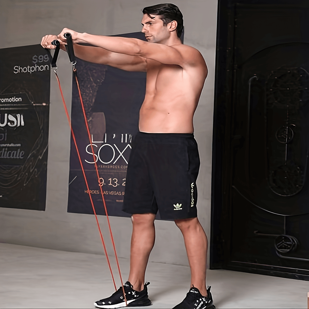 Man using colorful resistance bands for strength training at home gym.