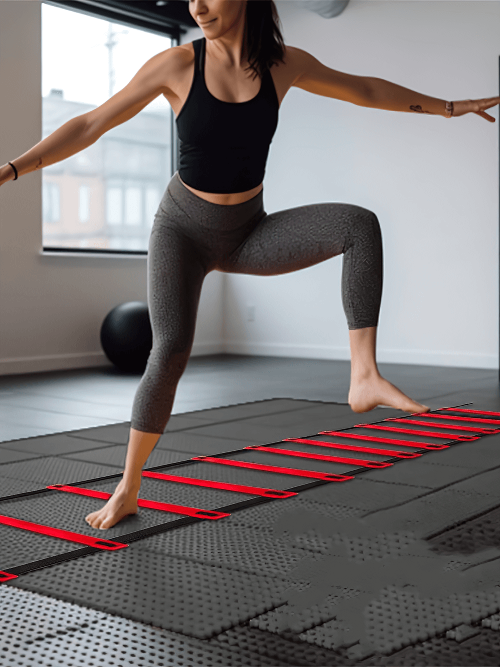 Athlete using 12-rung agility ladder for speed training indoors, enhancing agility and coordination. Ideal for fitness workouts and sports.