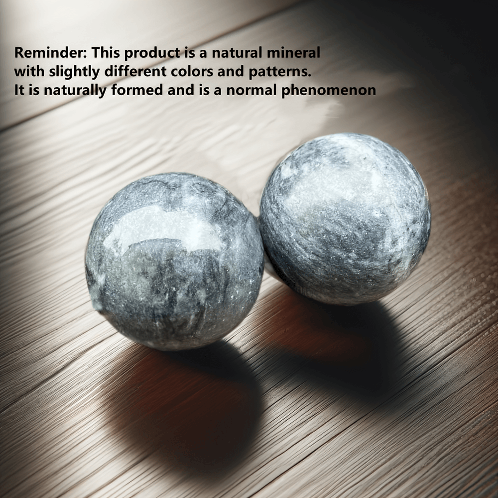 Pair of handcrafted natural stone Baoding balls for relaxation and focus, featuring unique patterns on a wooden surface.