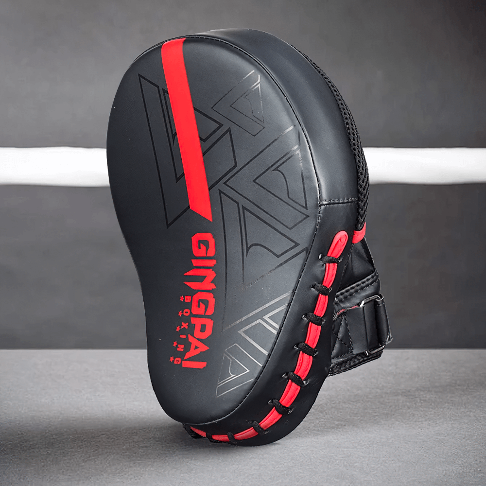 Black and red PU leather boxing target pad for training, featuring ergonomic design and Velcro closure for secure fit and impact absorption.