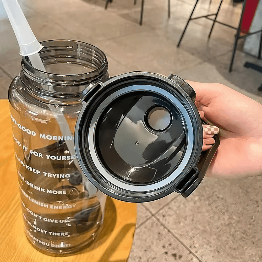 2L stylish sports water bottle with straw and motivational time markers, perfect for workouts and outdoor activities, shown with open lid.