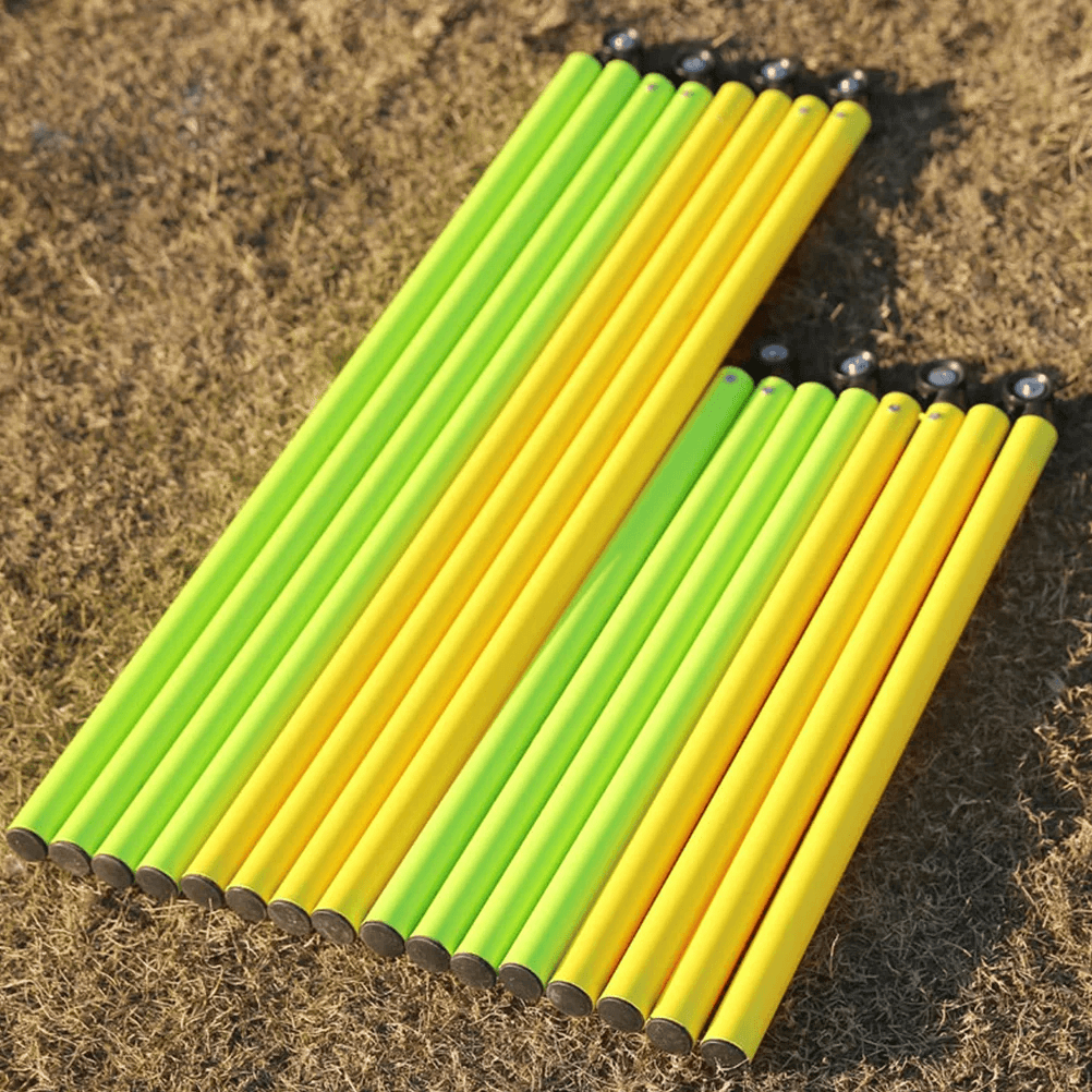 Yellow and green adjustable agility poles for soccer training on grass, perfect for footwork drills and outdoor exercises.