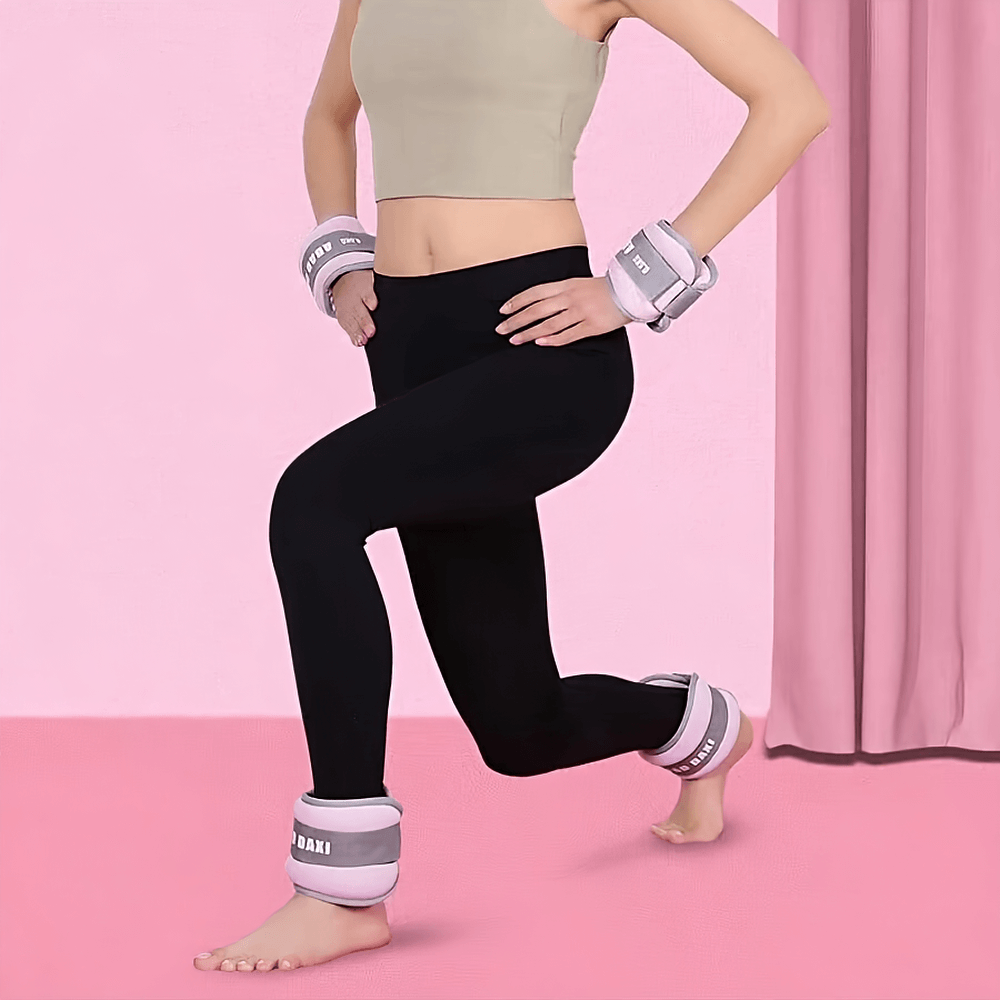 Woman exercising with adjustable ankle and wrist weights for yoga and fitness, demonstrating strength training gear on a pink background.