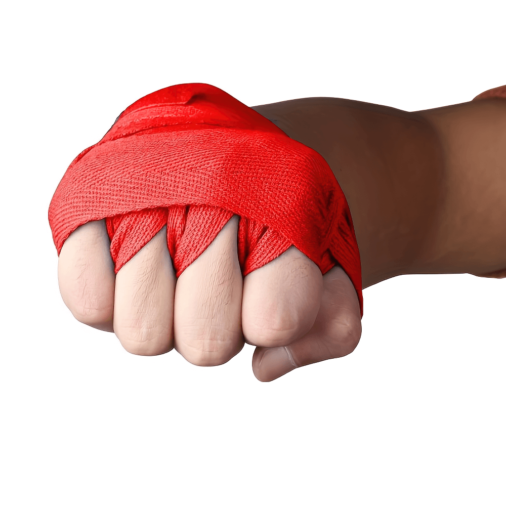 Close-up of a hand wrapped with red boxing and MMA hand wraps for wrist support and knuckle protection.