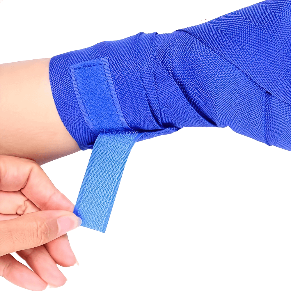 Person adjusting blue boxing hand wrap with hook and loop closure for wrist and fist support.