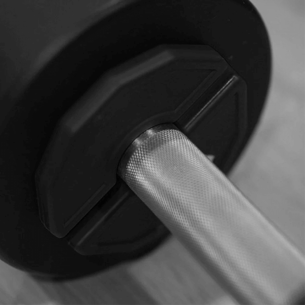Close-up of a barbell with a rubber-coated weight plate, showcasing durable design for strength training and home gym workouts.