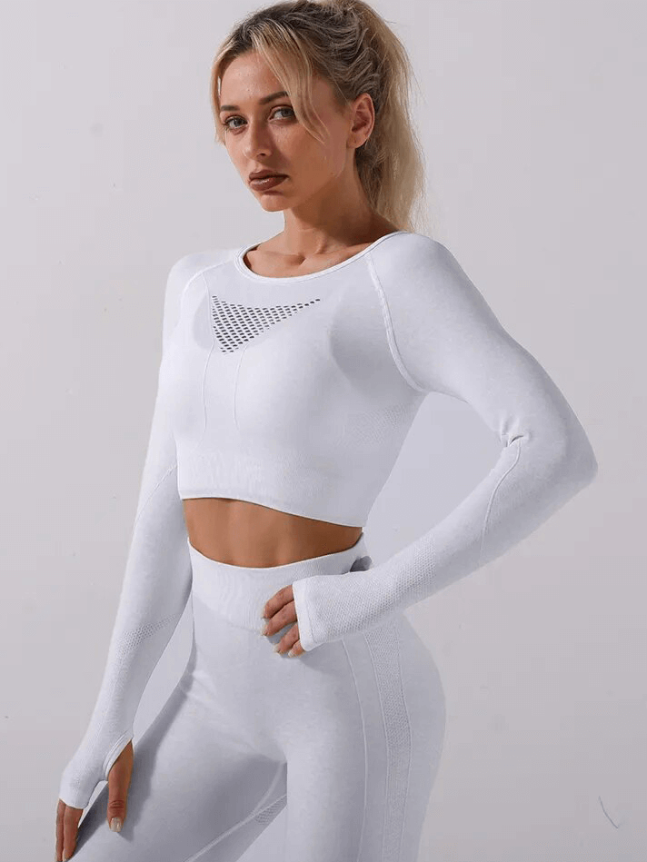 Woman in white seamless sports yoga set, full sleeves, nylon, anti-pilling, anti-shrink, windproof; perfect for yoga practice.