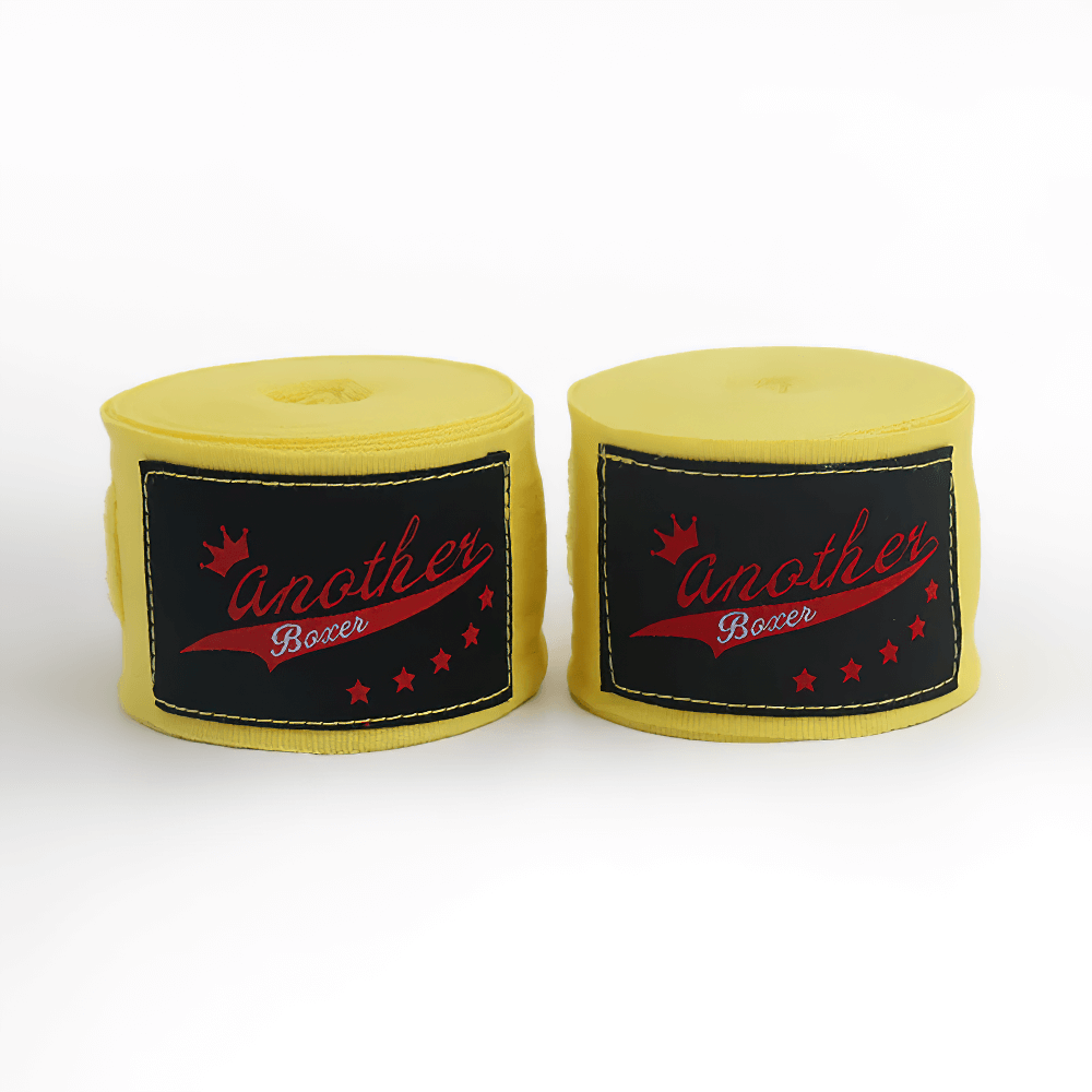 Yellow boxing hand wraps set with black labels featuring red text, designed for Muay Thai, MMA, kickboxing, and combat training.