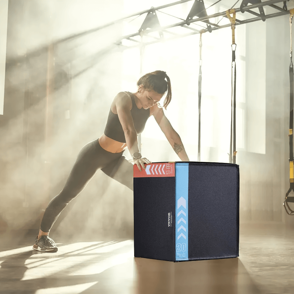 Woman using 3-in-1 soft plyo box in gym for jump training, featuring anti-slip surface and color-coded heights for versatile workouts.