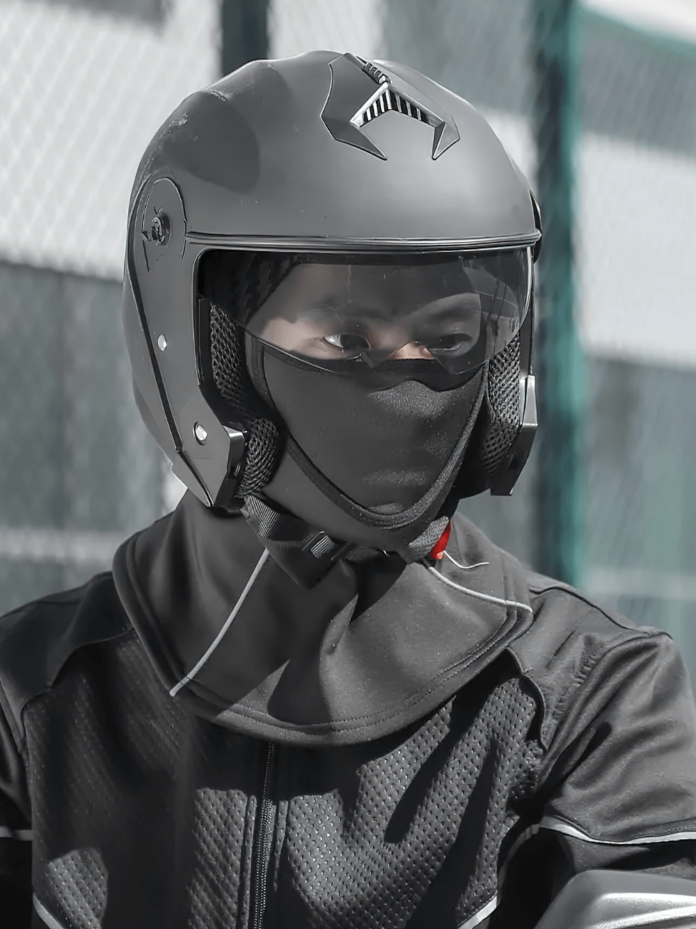 Motorcyclist wearing helmet and SF2505 thermal balaclava for windproof protection. Ideal for winter sports with breathable waffle pattern.