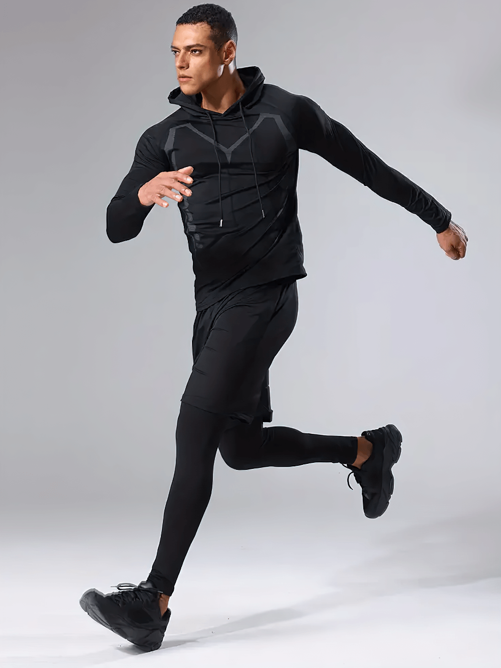 Man running in 3-piece sports hooded workout set SF2622, featuring black hoodie, shorts, and compression tights for men’s fitness.