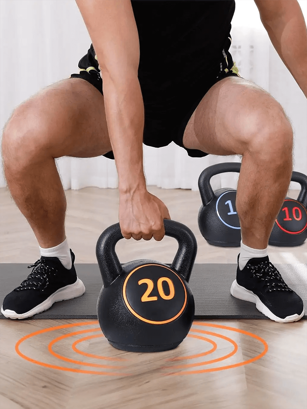 Man lifting 20lb kettlebell from 4-piece weight set for home gym strength training, featuring durable design for beginners and athletes.