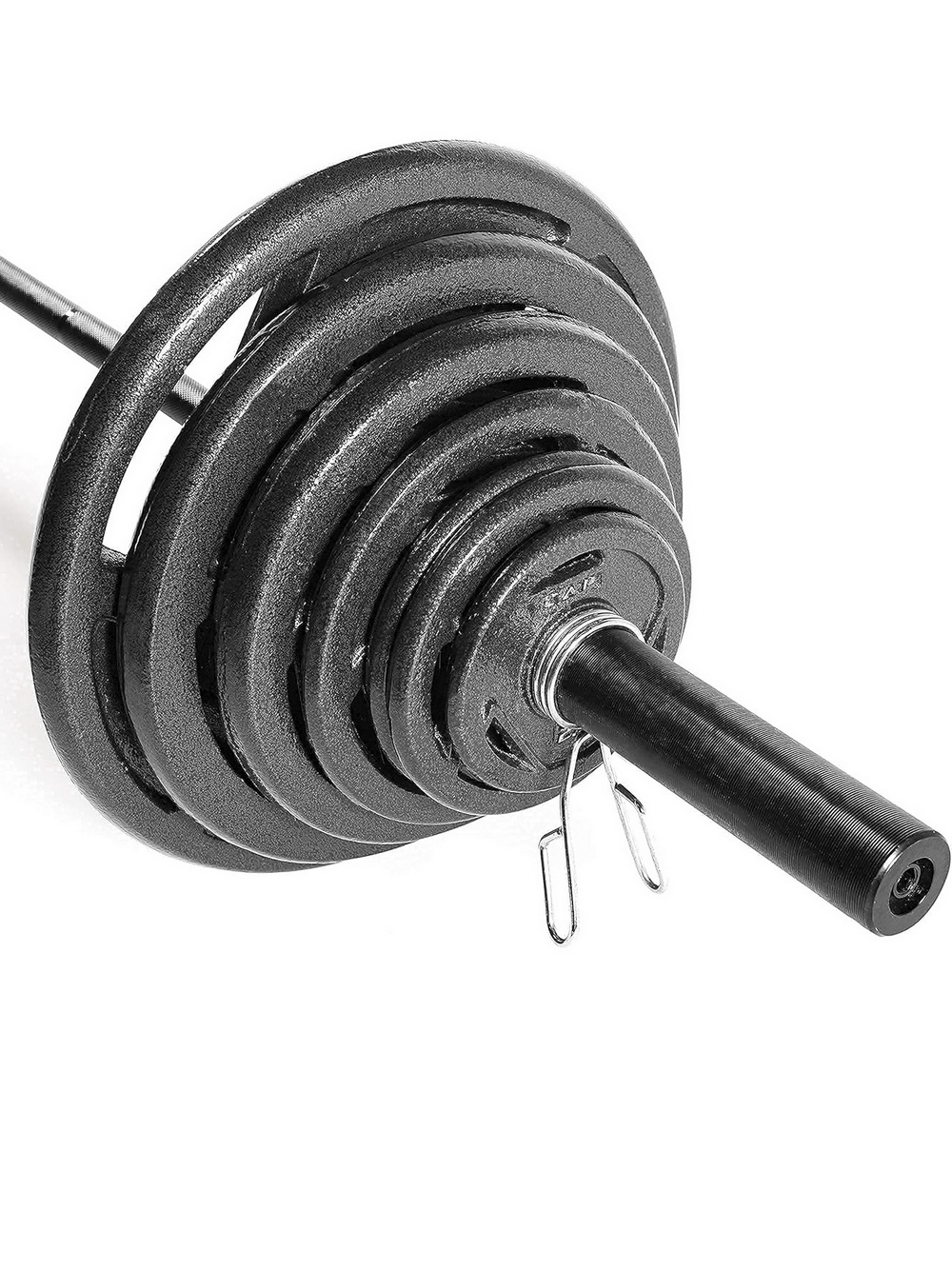 Stacked cast iron weight plates on an Olympic bar, ideal for strength training and home workouts.