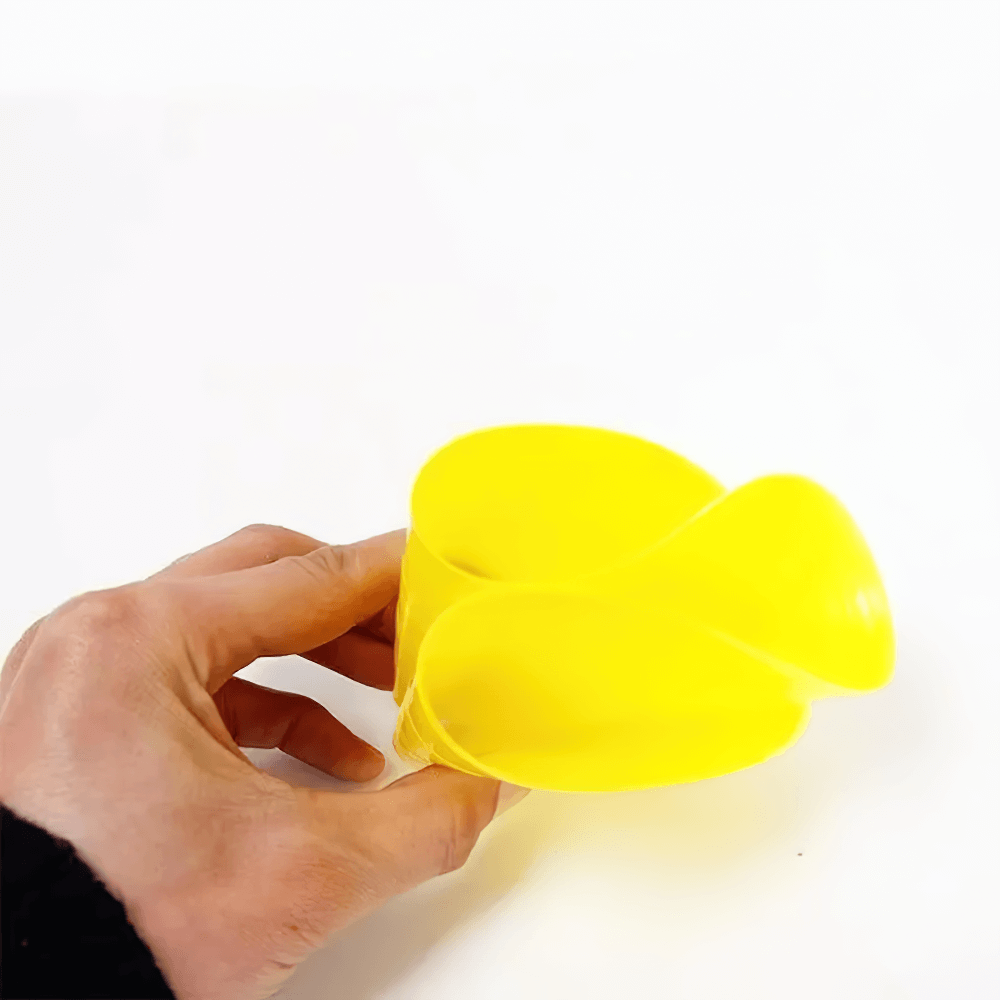 Hand holding a yellow flexible agility cone from the SF3199 set for sports training and drills.