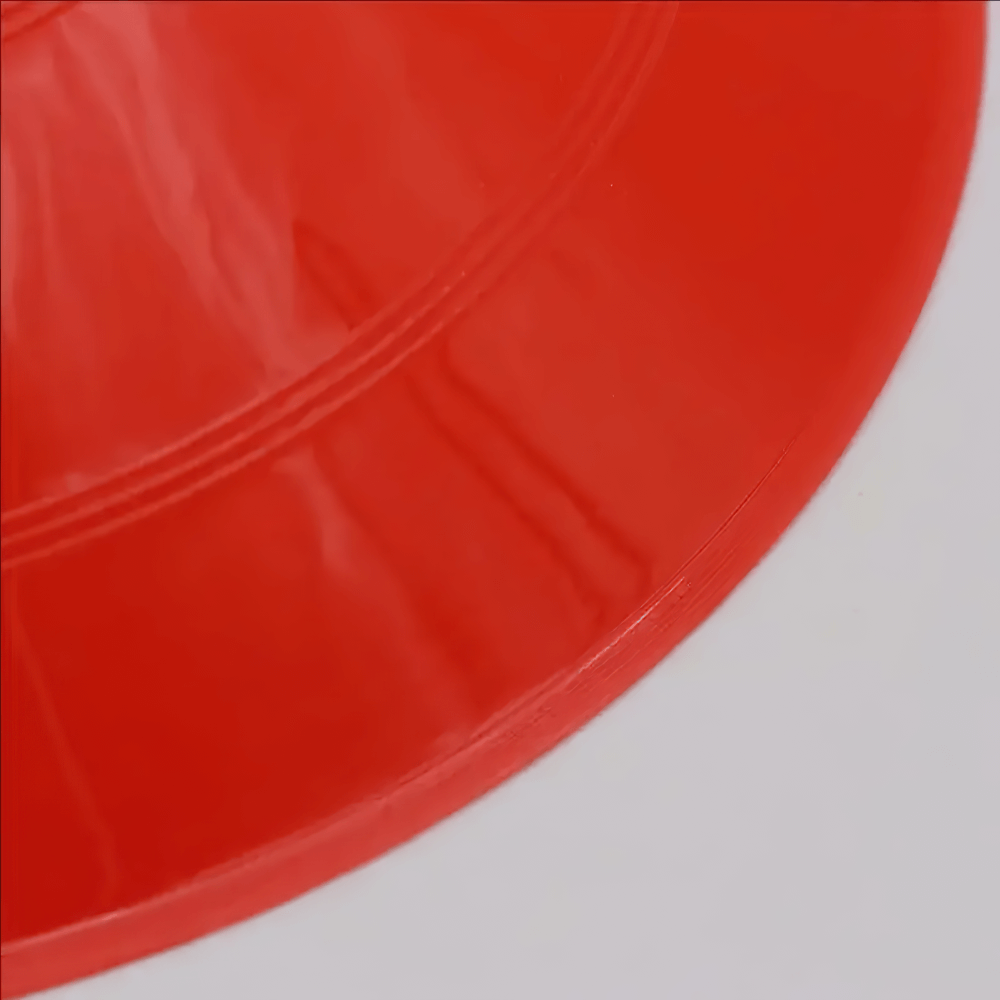 Close-up of a vibrant red agility training cone, ideal for enhancing sports drills and footwork.