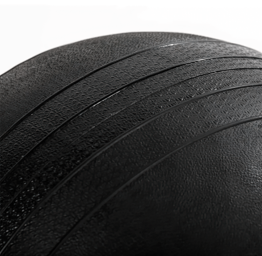 Close-up of Titan Fitness 60 LB textured black slam ball, designed for workout grip and durability.