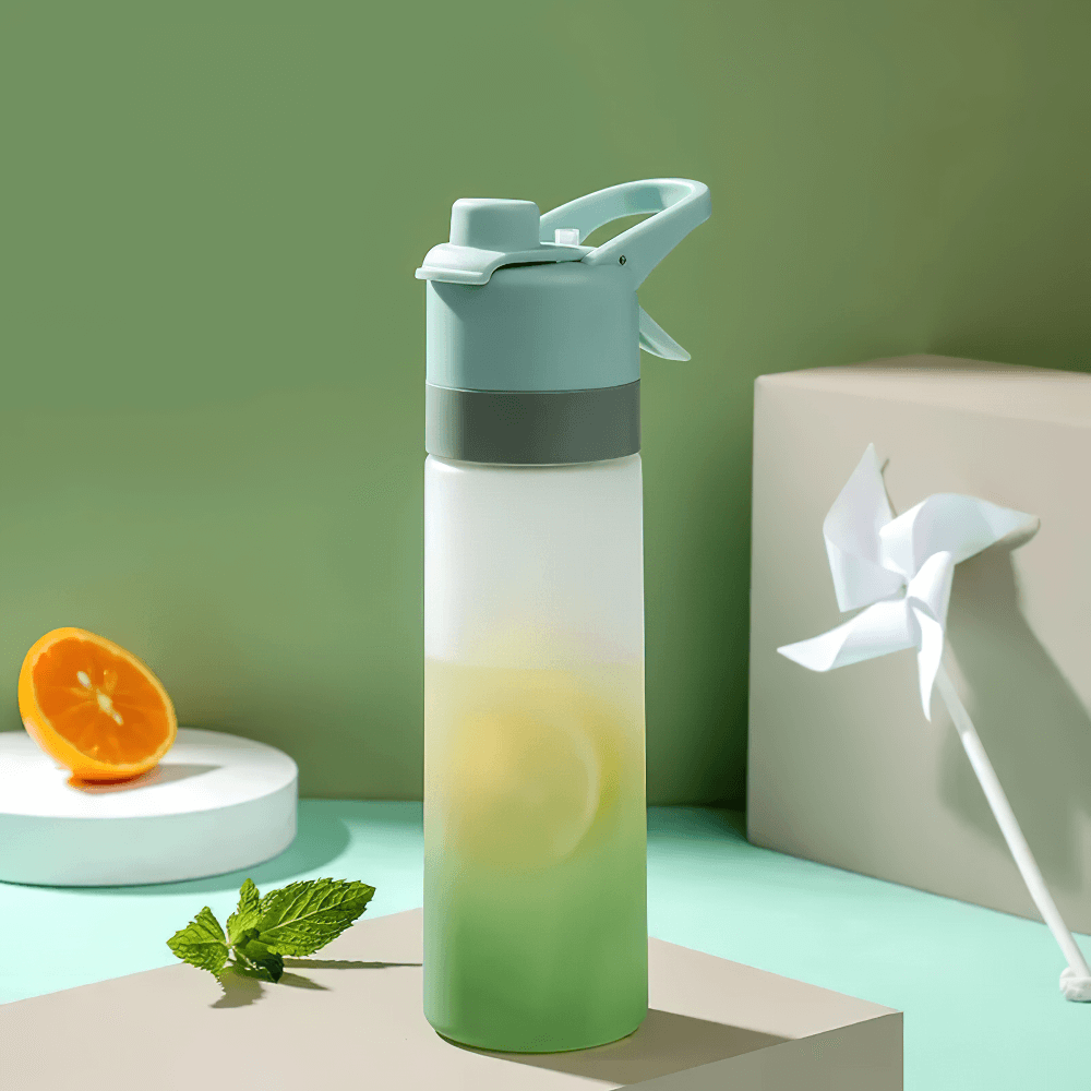 650ml Spray Water Bottle for Outdoor Activities - SF3492 on a stylish backdrop with lemon and mint, perfect for gym and travel hydration.