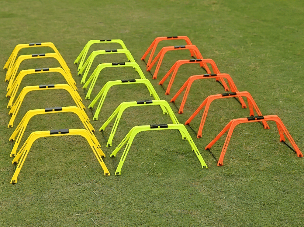 Colorful modular hexagonal hurdles and connectors set on grass, perfect for agility training and fitness drills. SF3169 agility kit.