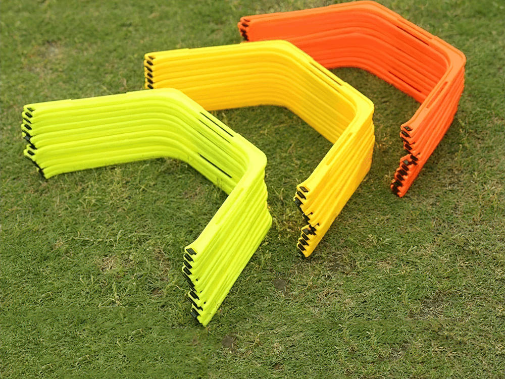 Vibrant 6-piece modular hexagonal hurdles and connectors set on grass for agility training and fitness drills.