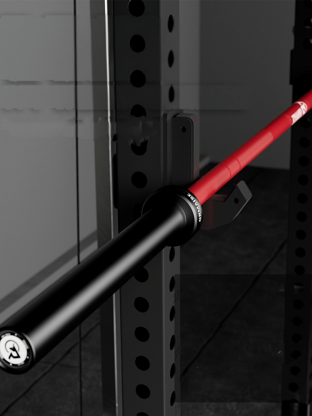 Close-up of a 7ft dual-marked barbell with red hybrid sleeves and smooth rotation bearings resting on a power rack.