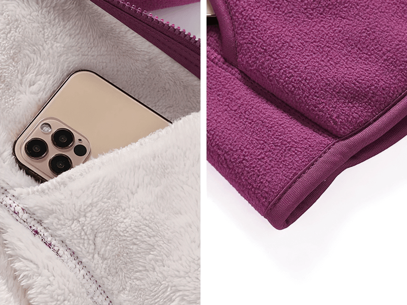 Close-up of a purple zip-up fleece jacket with inner pocket holding a smartphone, showcasing soft texture and practical design.