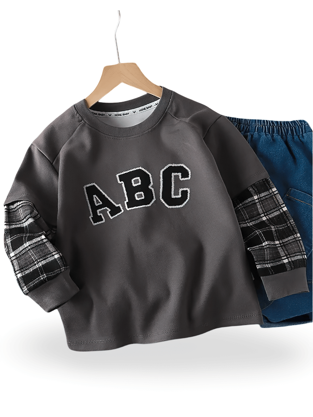 Trendy kids sweatshirt with ABC print and plaid sleeves, perfect for school or play. Comfortable and stylish choice for active children.