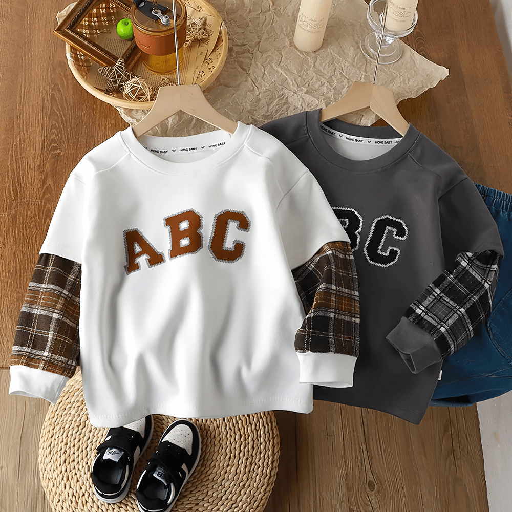 ABC lettered kids sweatshirts with plaid sleeves, showcasing modern style and comfort for active children.