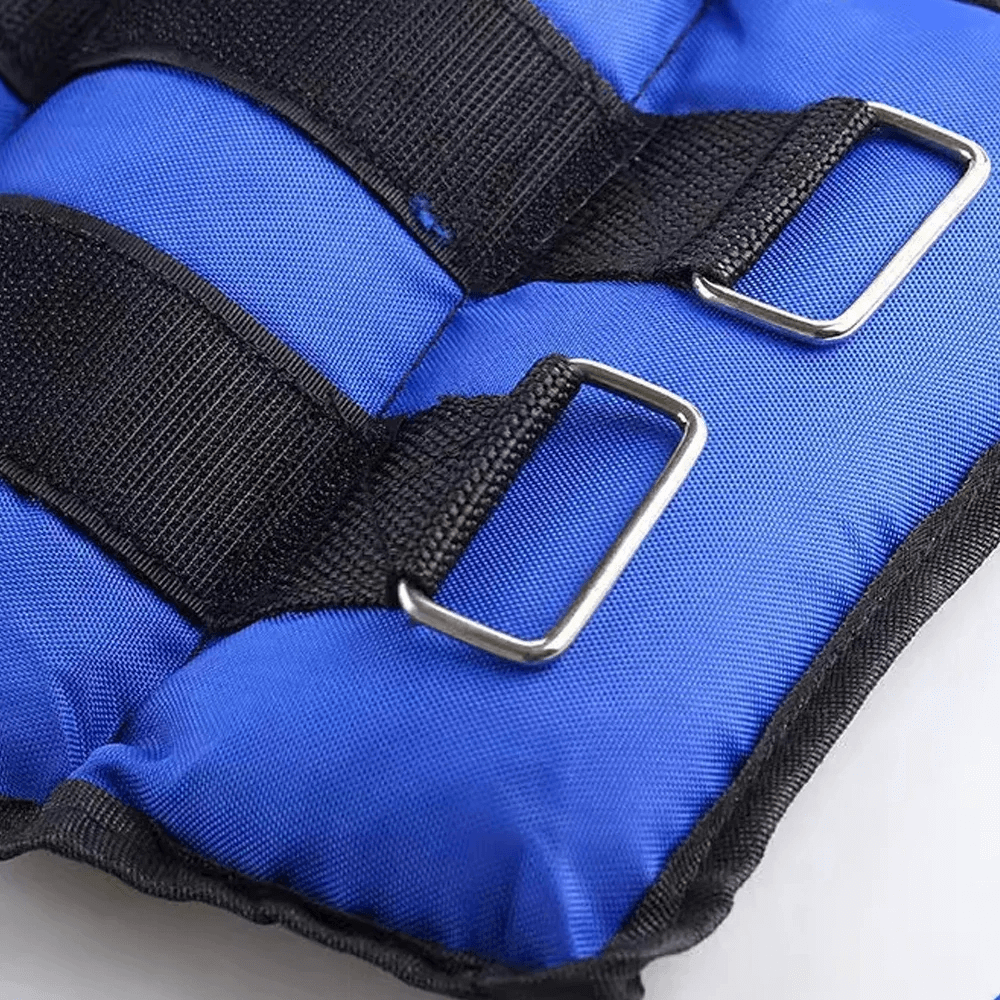 Close-up of adjustable ankle and wrist weights in blue with velcro straps and reinforced stitching for resistance training.