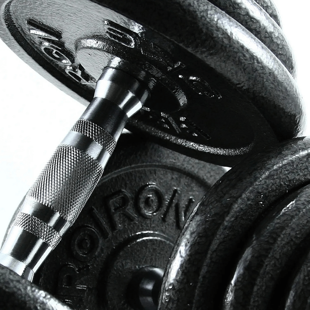 Close-up of adjustable cast iron dumbbell bar with weights. SF3335 fitness equipment for strength training and exercise.