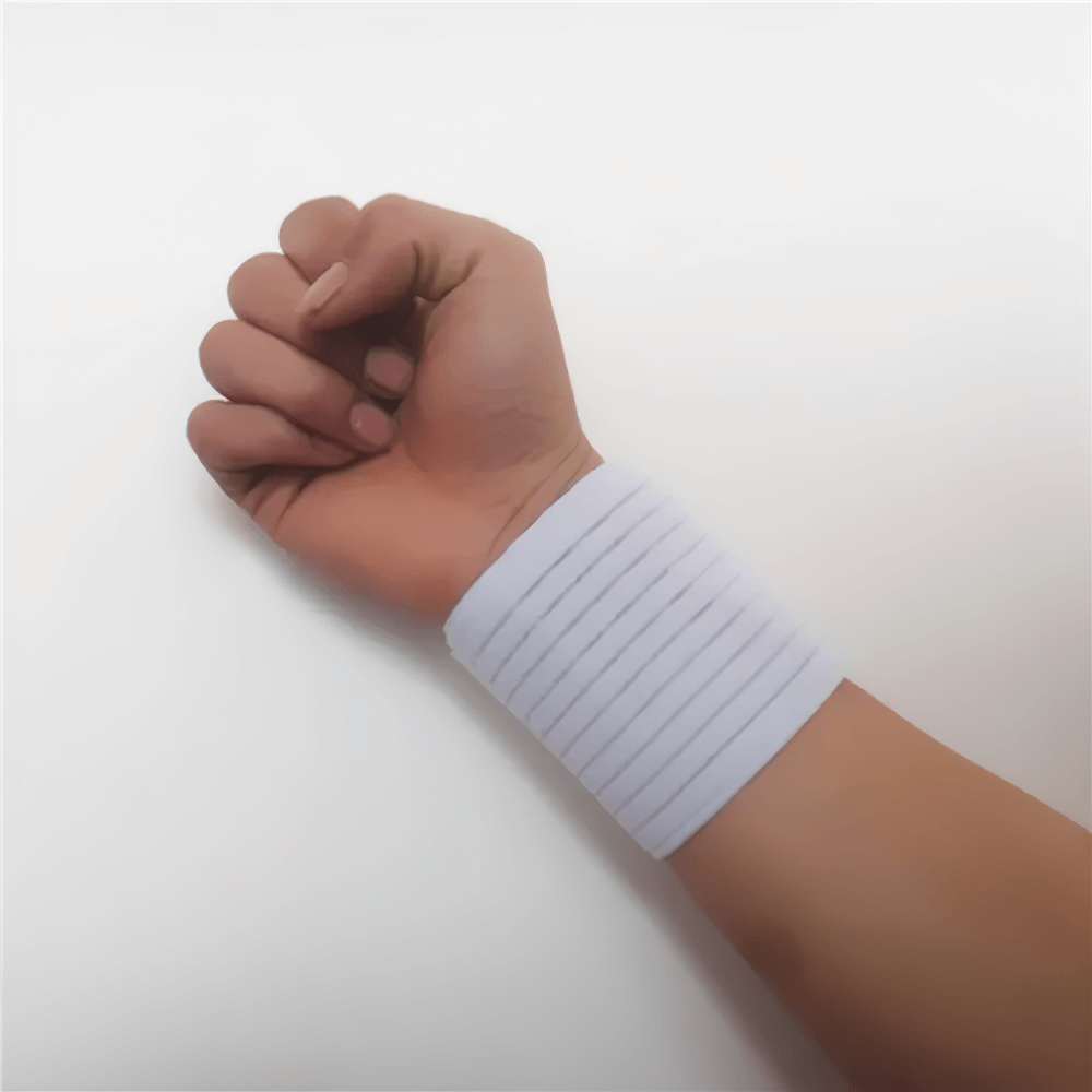 Person wearing adjustable elastic sports wristband brace for wrist support and stability during fitness workouts, in white.