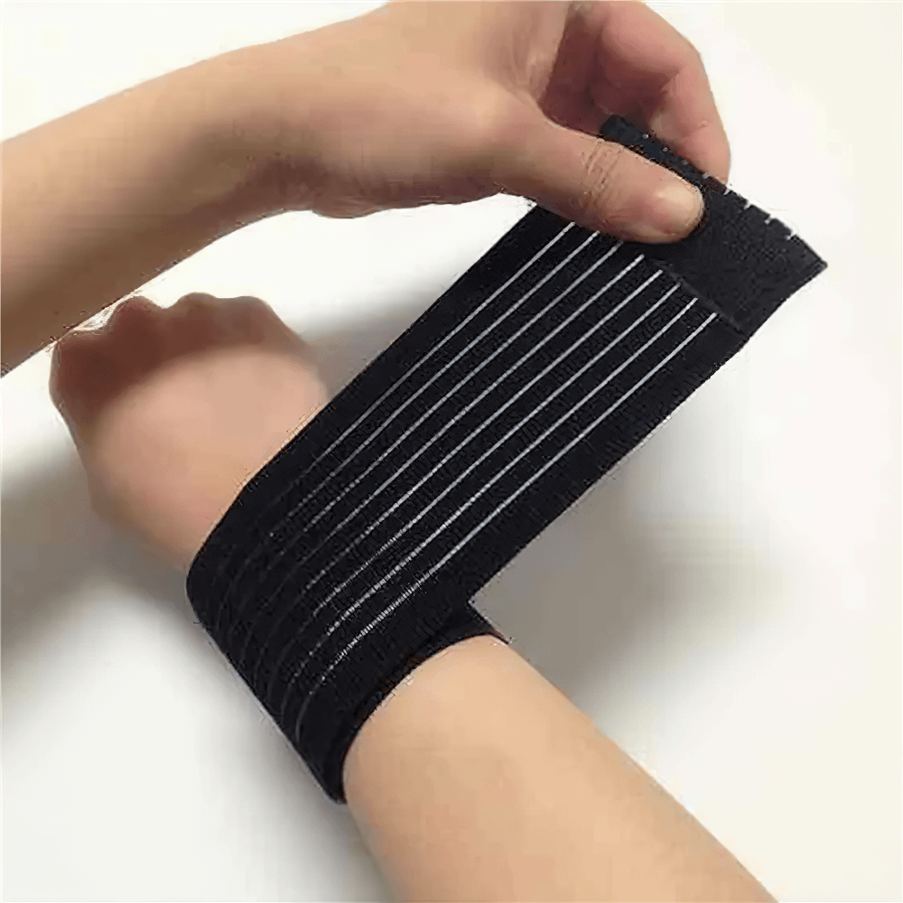 Person wearing adjustable elastic sports wristband for joint support and stability during workouts.