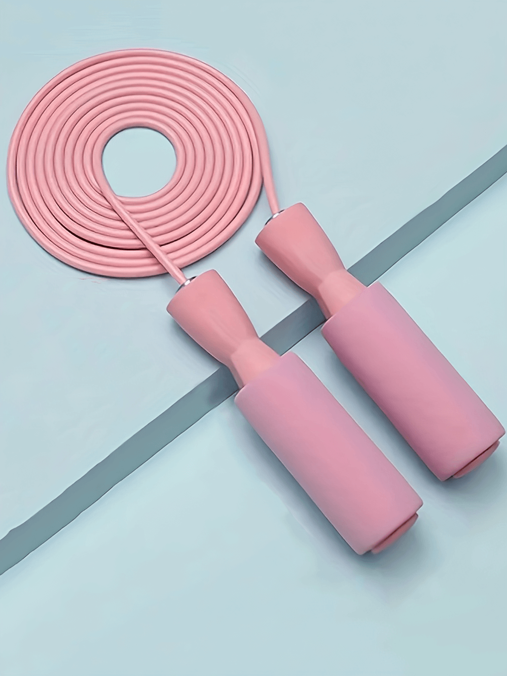 Adjustable pink jump rope with thickened foam handles and wire-core design for fitness and cardio workouts.