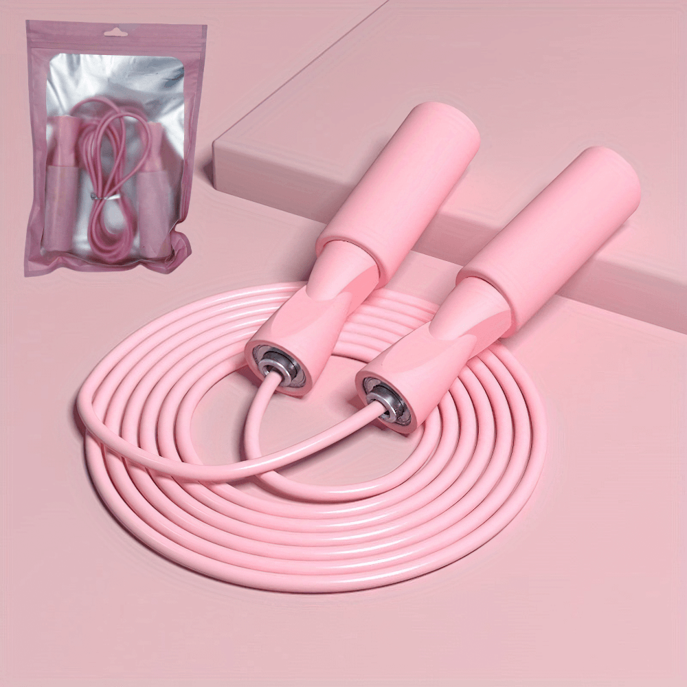 Pink adjustable jump rope with ergonomic handles, showcased coiled on a pink surface, perfect for fitness and cardio workouts.