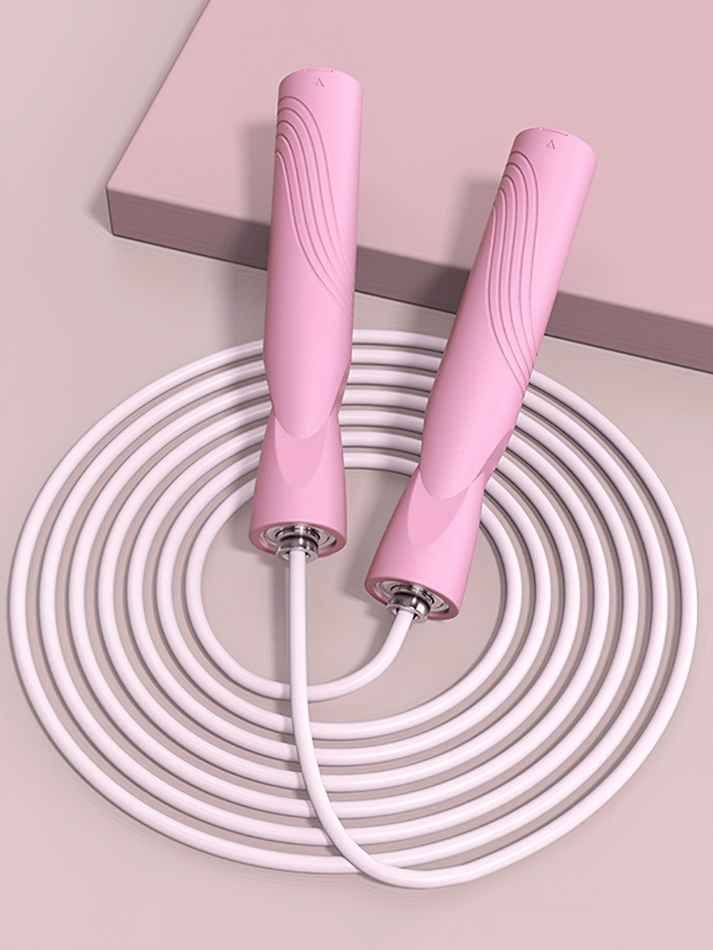 Pink adjustable speed jump rope with ergonomic handles and tangle-free design, ideal for fitness and cardio workouts.