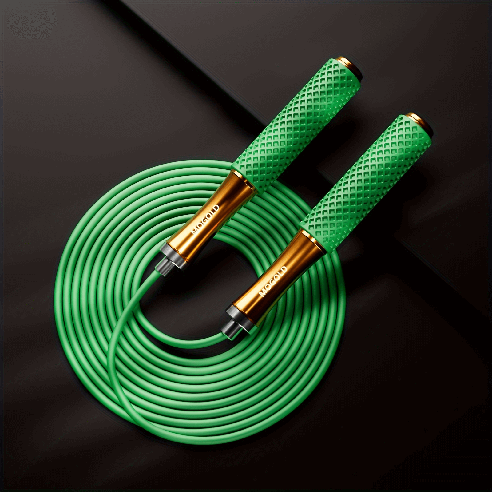 Green adjustable speed jump rope with silicone handles and ball bearings, coiled on a black surface.