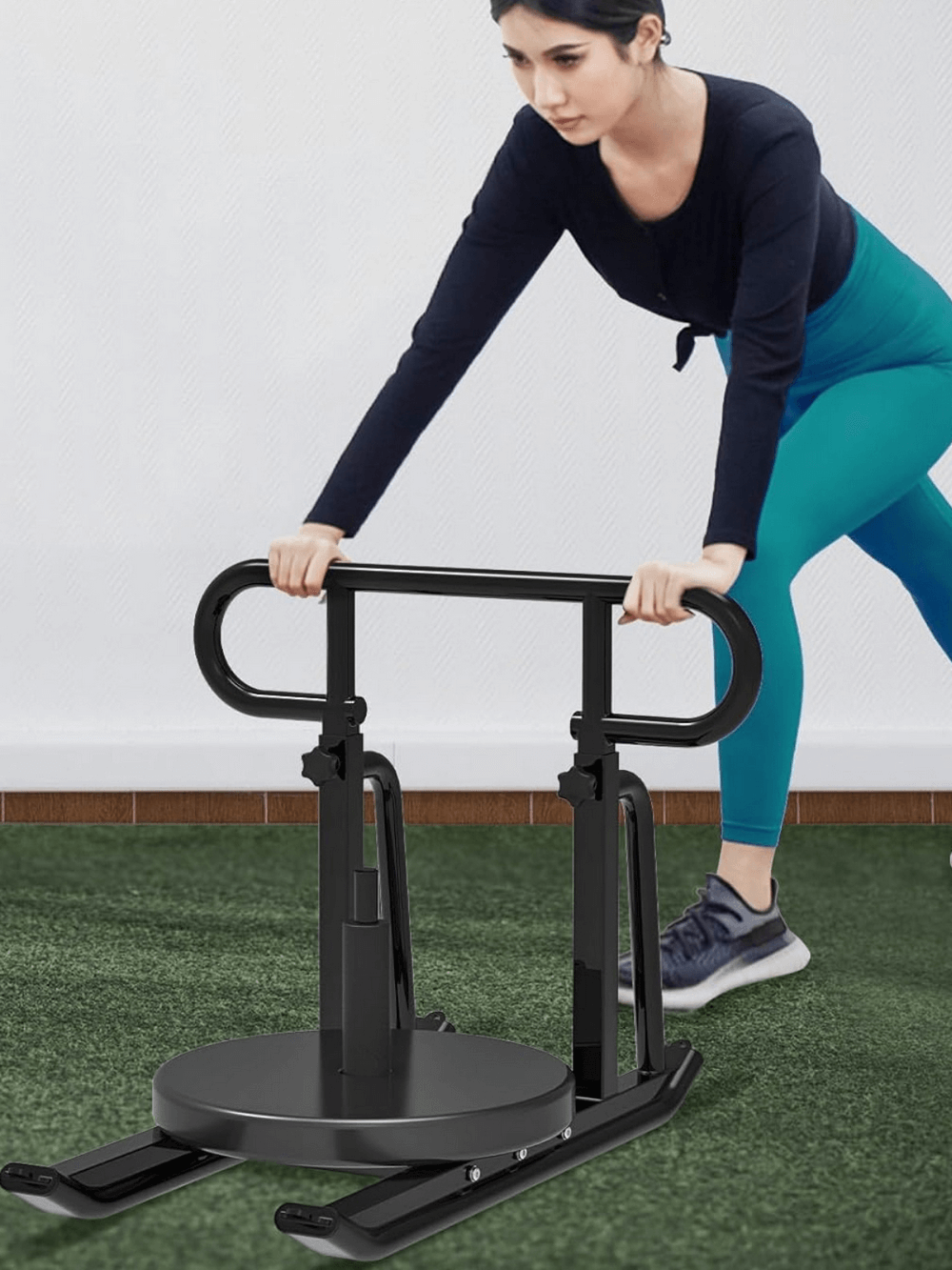 Woman using adjustable speed training sled SF2894 for strength and endurance workouts on green turf.