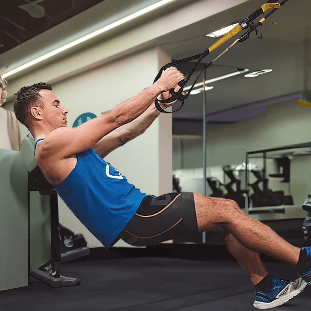 Man using adjustable suspension training straps for a full body workout in a gym setting.