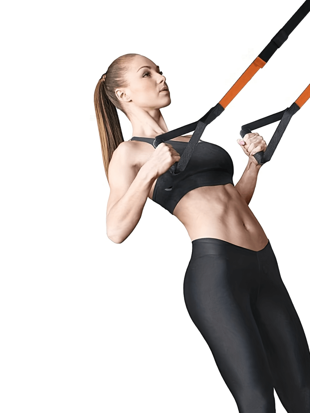 Woman using adjustable suspension training straps for strength training workout indoors.