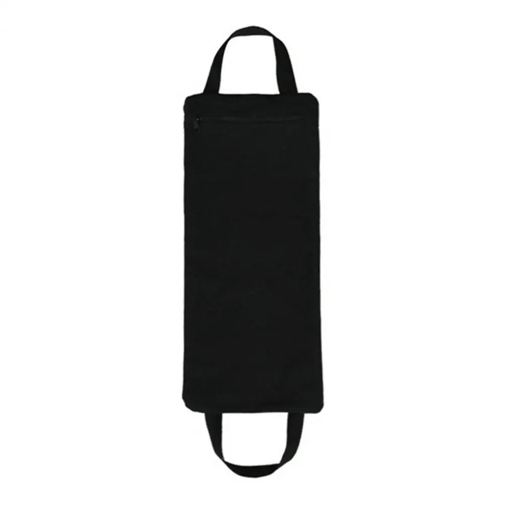 Adjustable black sandbag for yoga and Pilates with secure zipper and handles, ideal for home or outdoor workouts and strength training.