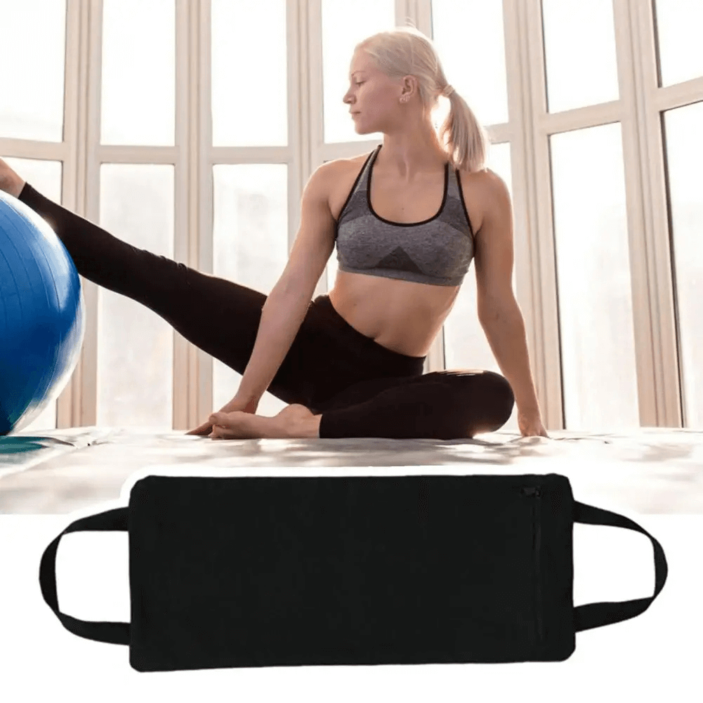 Woman practicing yoga with adjustable sandbag and stability ball, enhancing flexibility and strength in a bright studio setting.