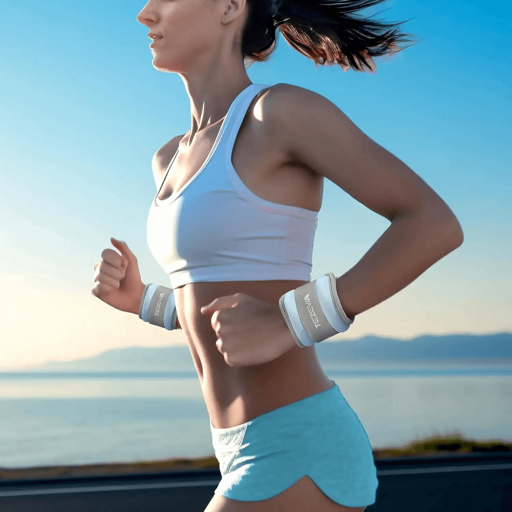 Woman running by the sea with adjustable wrist weights, ideal for fitness and yoga training, promoting active lifestyle and flexibility.