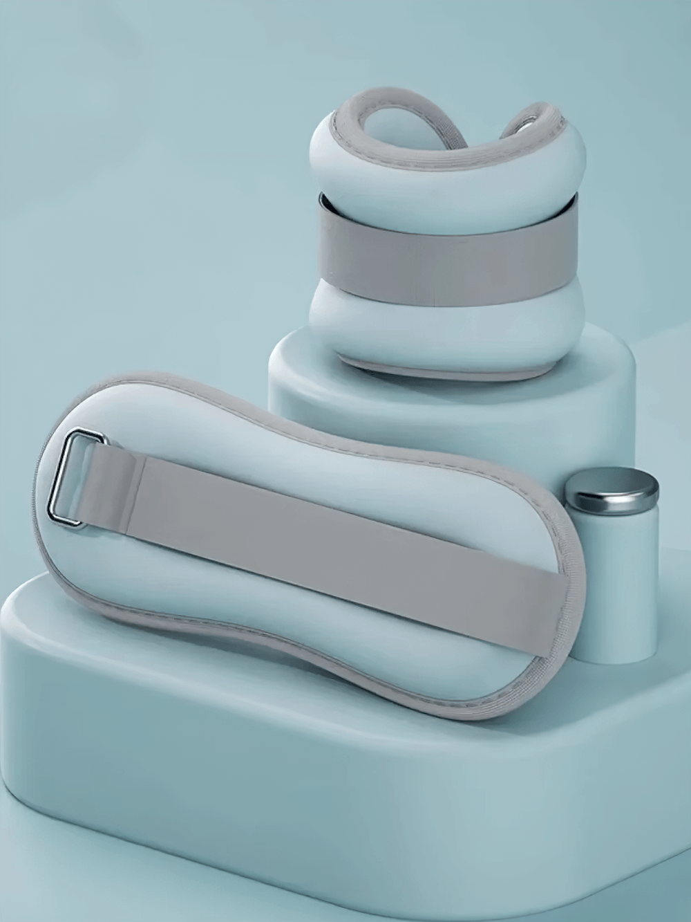Adjustable wrist and ankle weights in pastel blue, perfect for workouts, with secure velcro strap and soft lining for comfort.