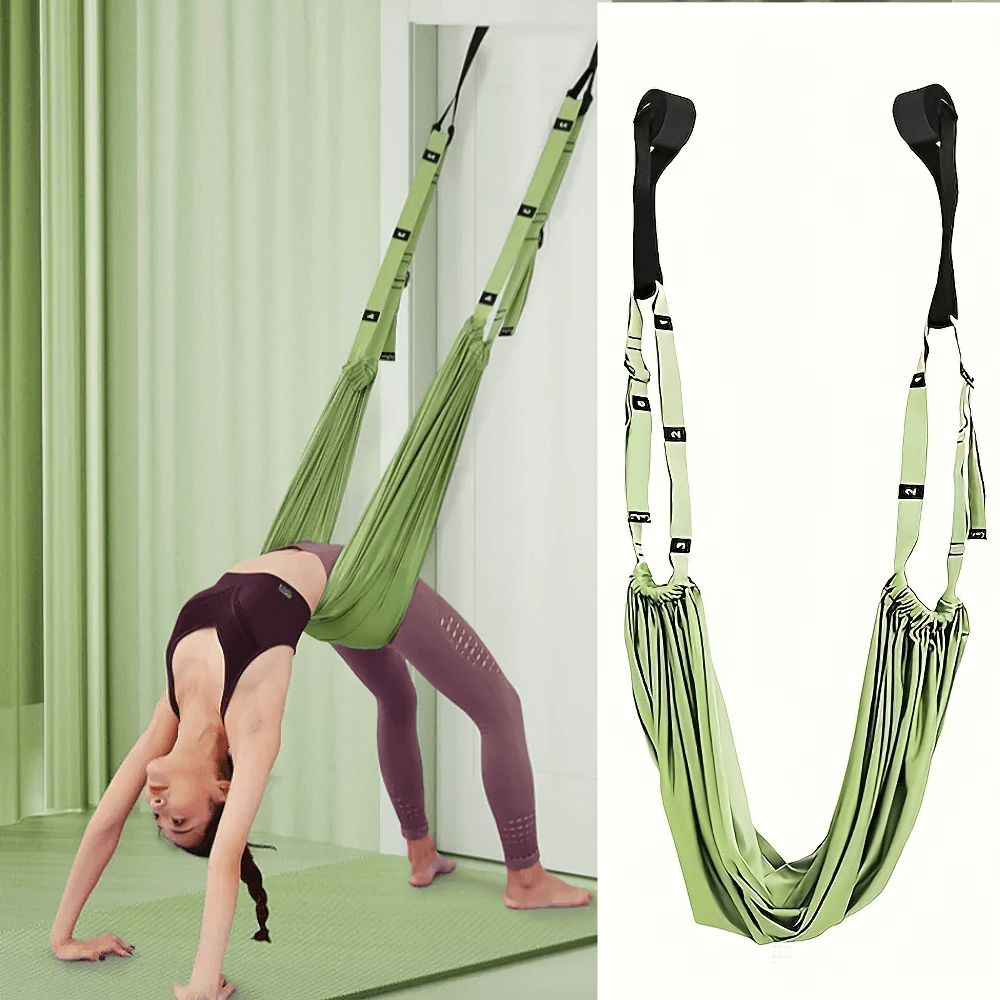 Woman using aerial yoga hammock for deep stretching and inversion therapy, enhancing flexibility and strength in home gym.