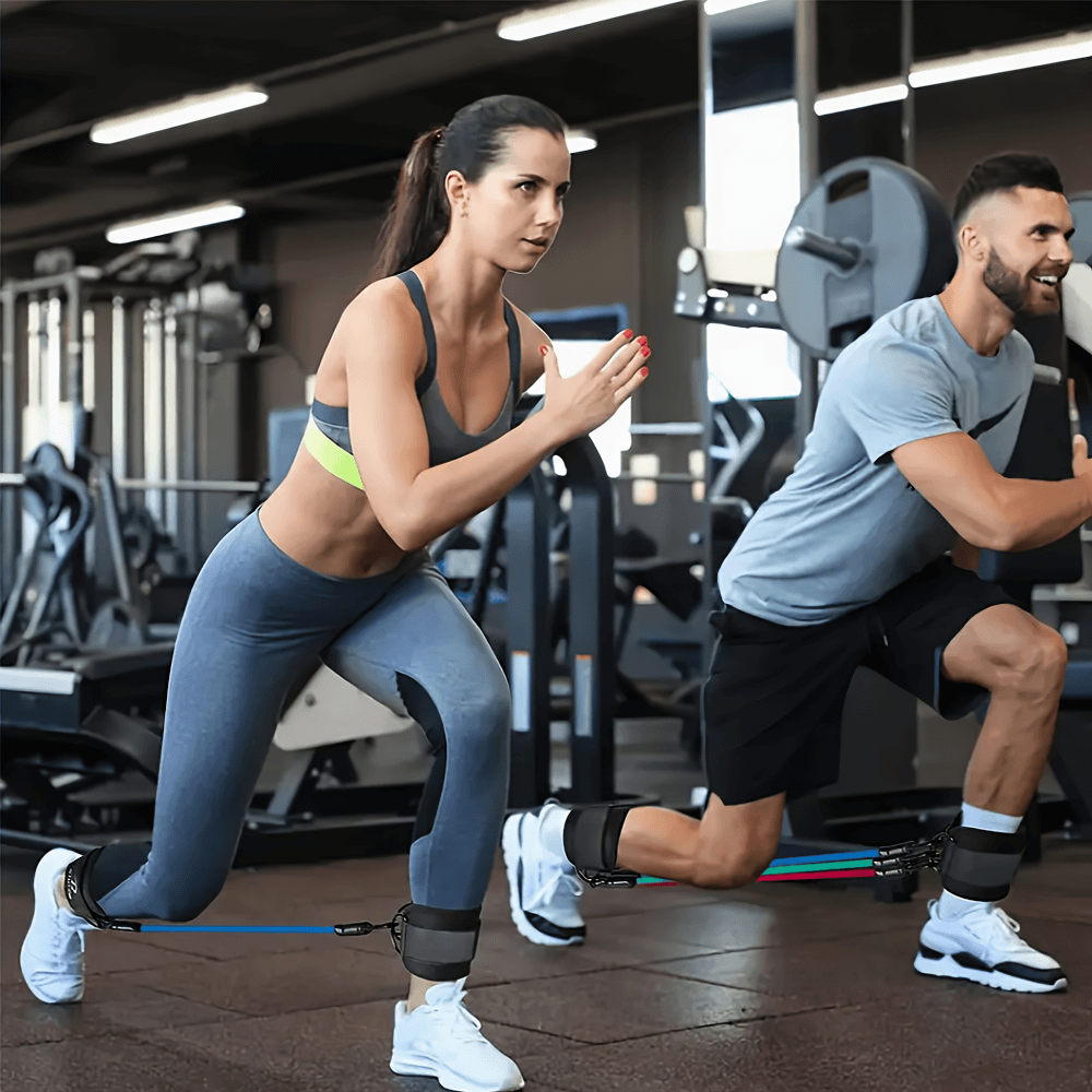 Man and woman exercising with ankle resistance bands in gym for leg and glute training, using SF3002 5-piece set.