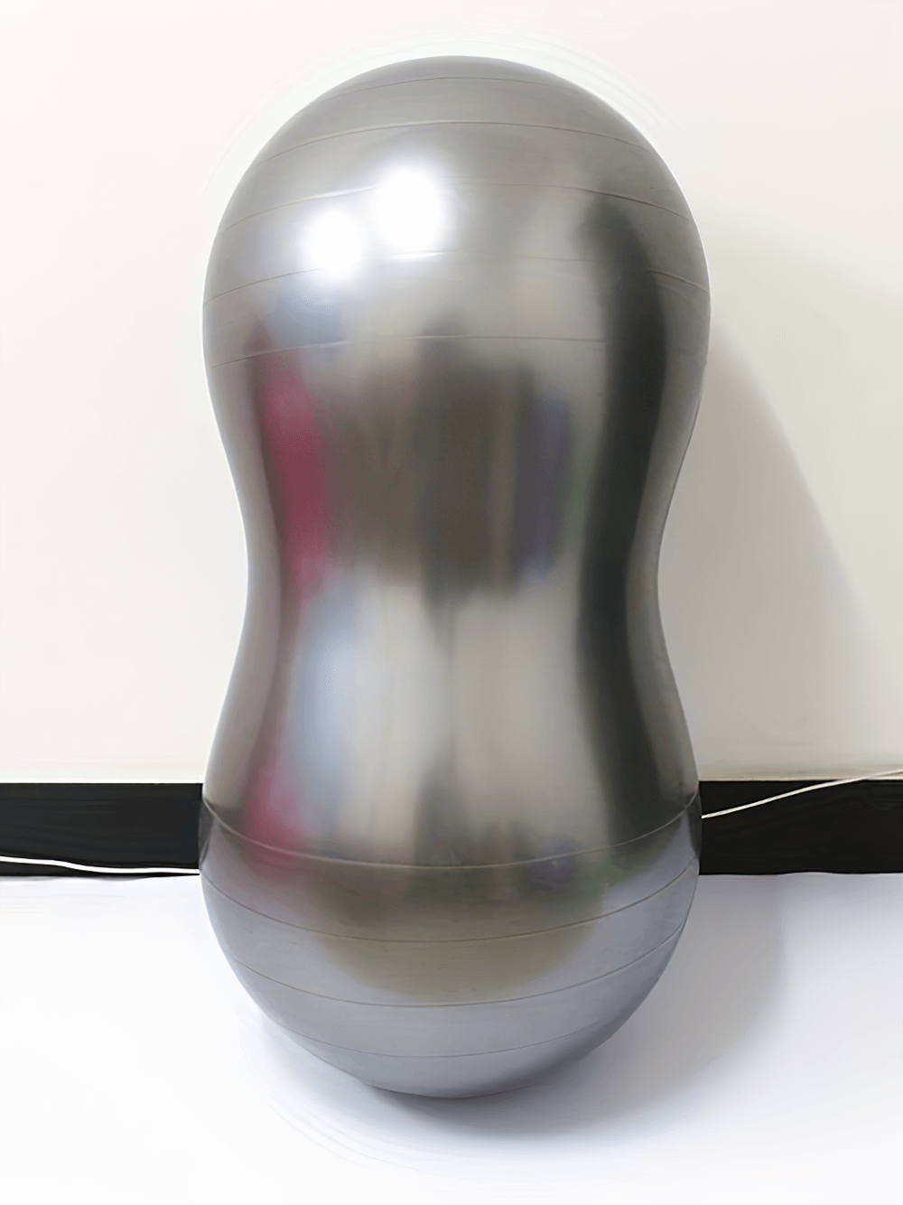 Silver anti-explosion peanut-shaped yoga ball for core strength, stability, and flexibility training, ideal for fitness and rehabilitation.