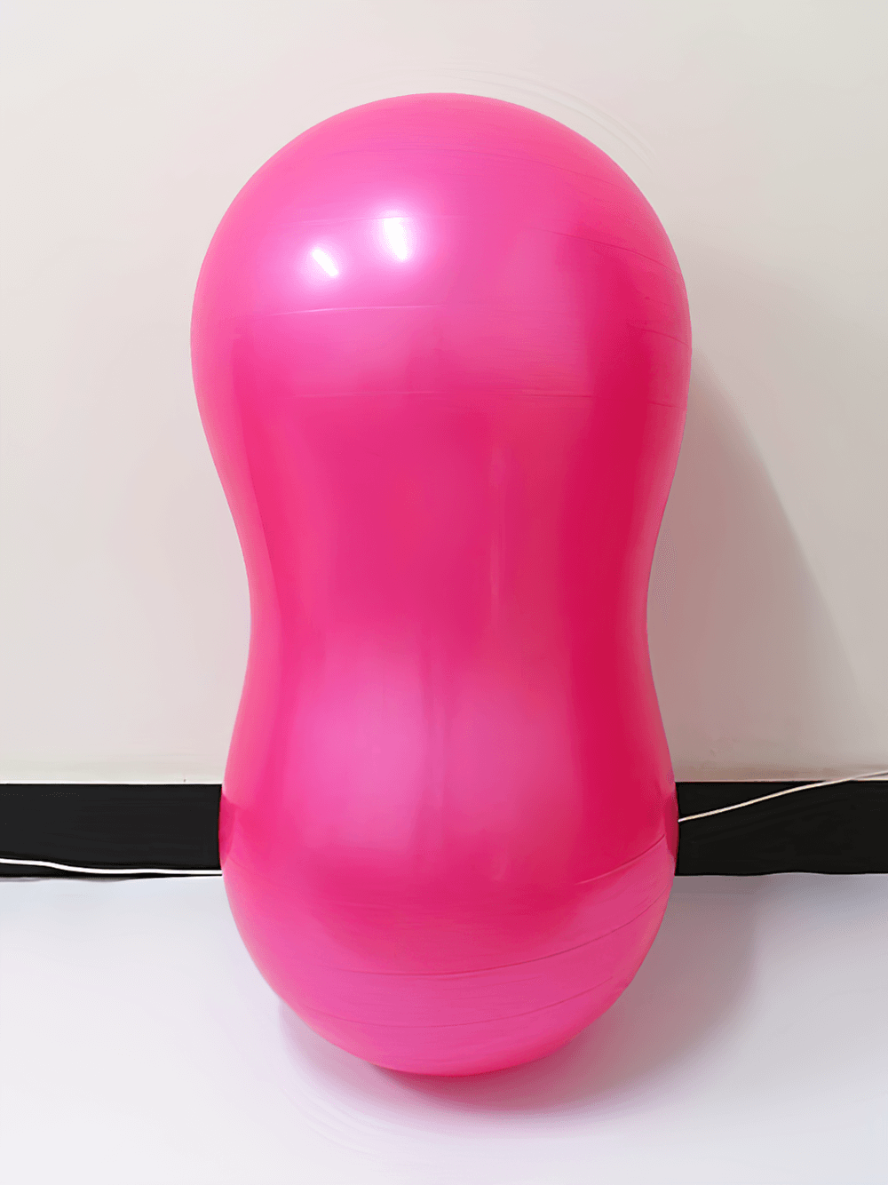 Bright pink anti-explosion peanut yoga ball for fitness, enhancing core strength, stability, posture, and flexibility.